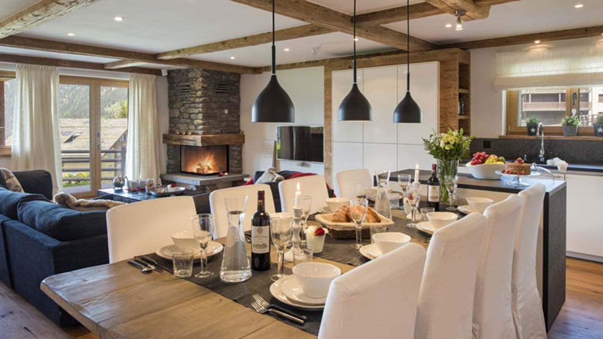 Open-plan dining area with wood-burning fireplace and seating for 8