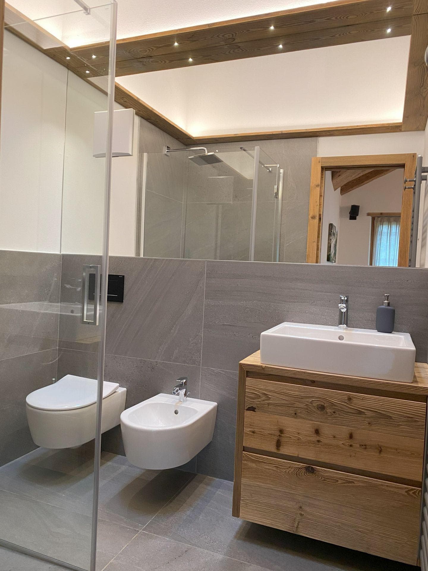 Bathroom with walk-in rainfall shower, bidet, and vessel sink