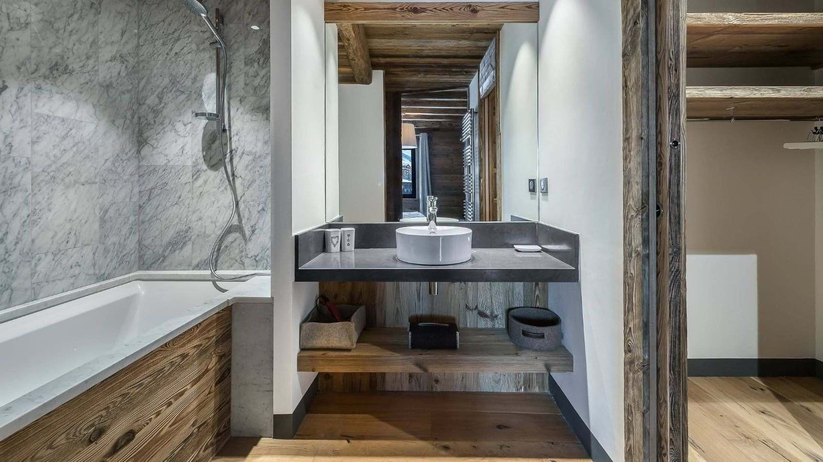 Bathroom with floating vanity, dark countertop, and open shelving for storage