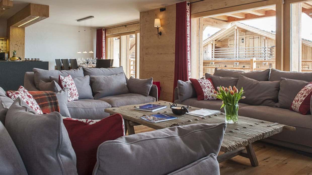 Open-plan living area with sectional seating and access to private balcony