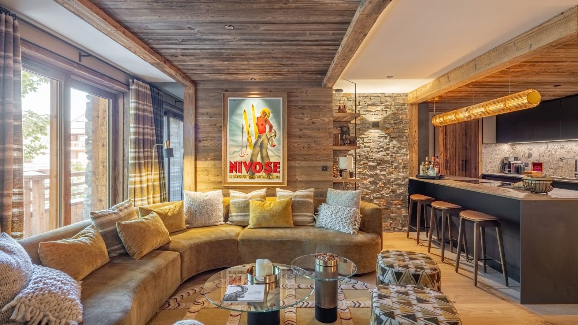 Open living area with curved sectional and breakfast bar seating for 4