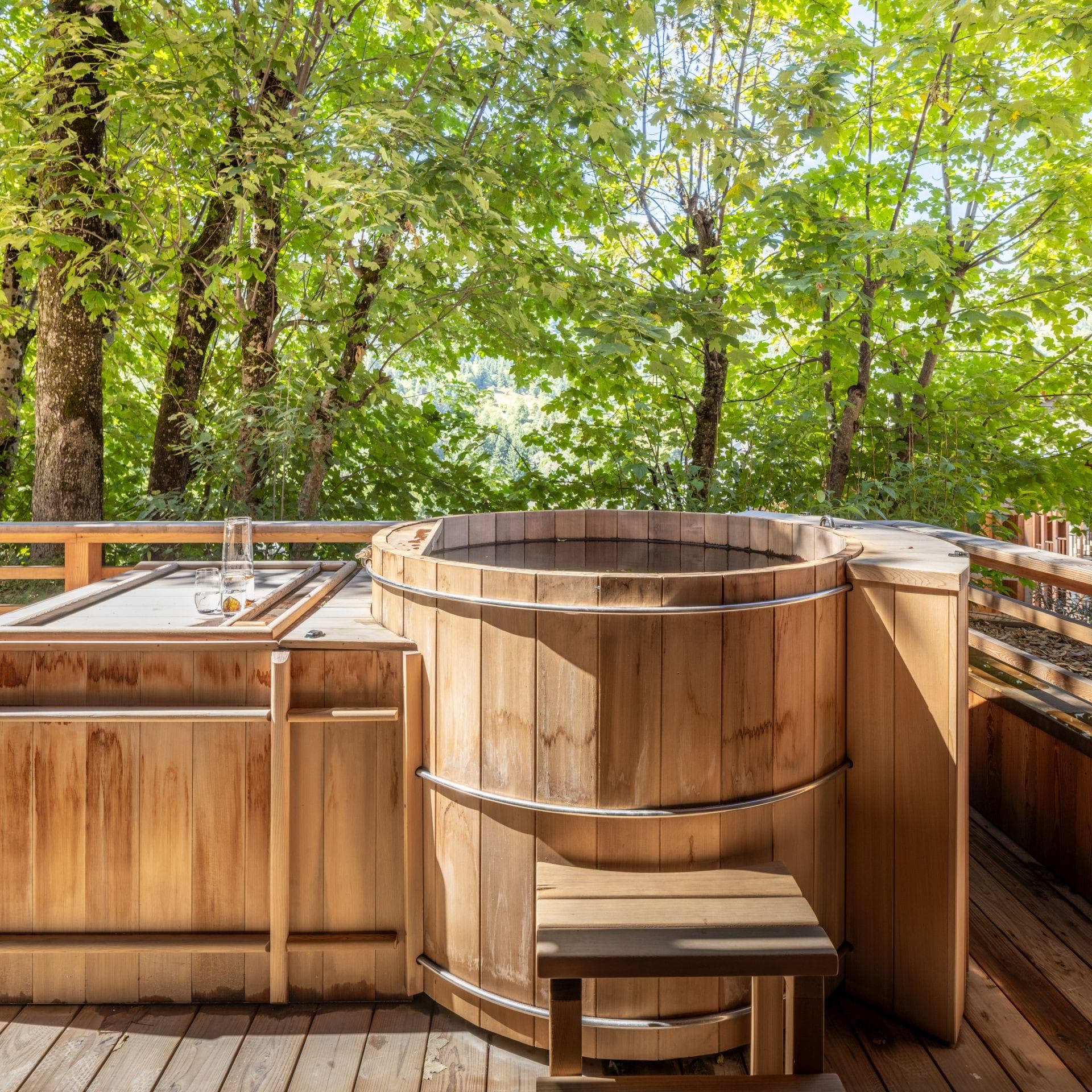 Cedar hot tub with wooded privacy and drink rail seating