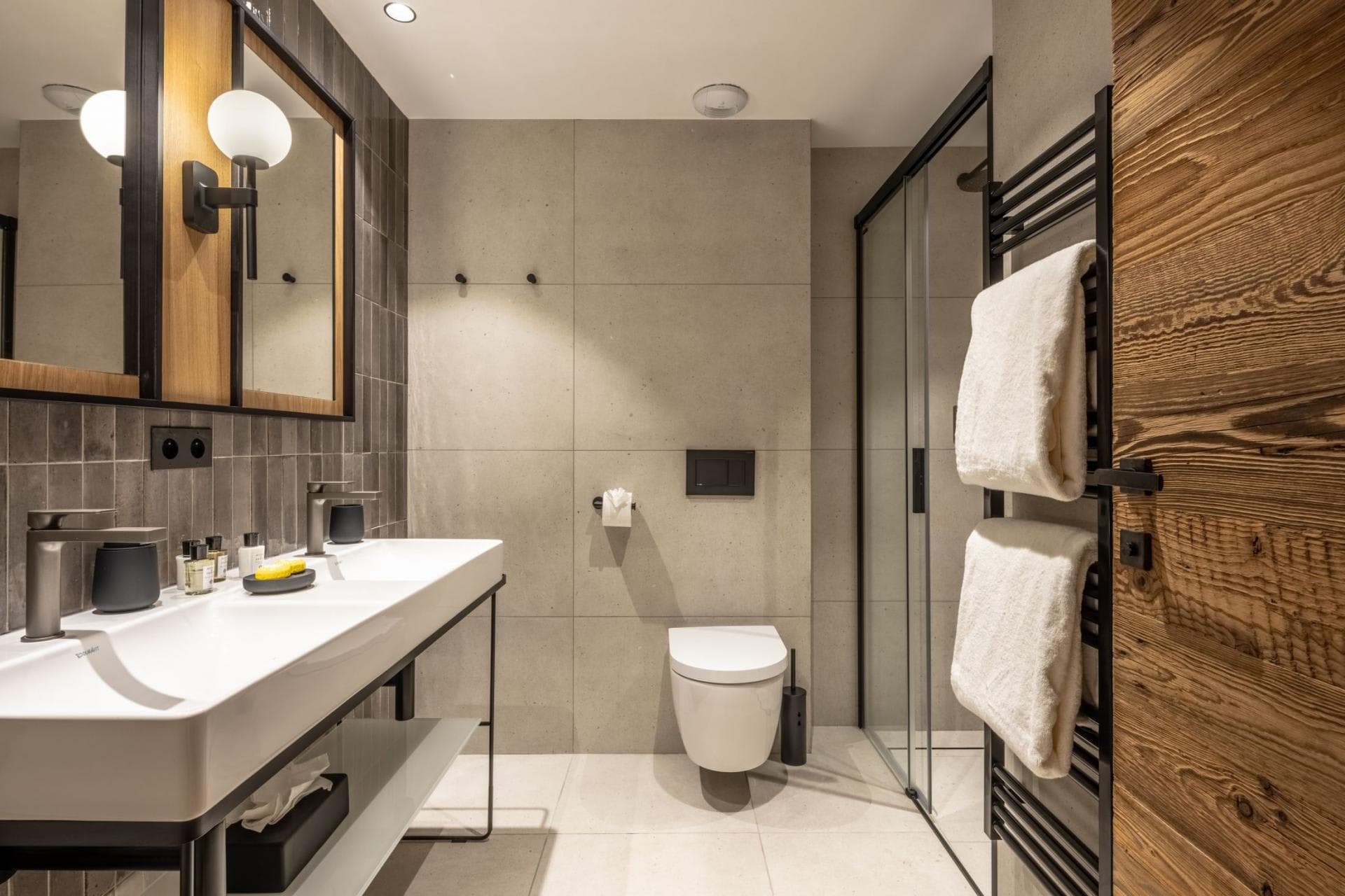Bathroom with dual vanity, walk-in shower, and heated towel rail