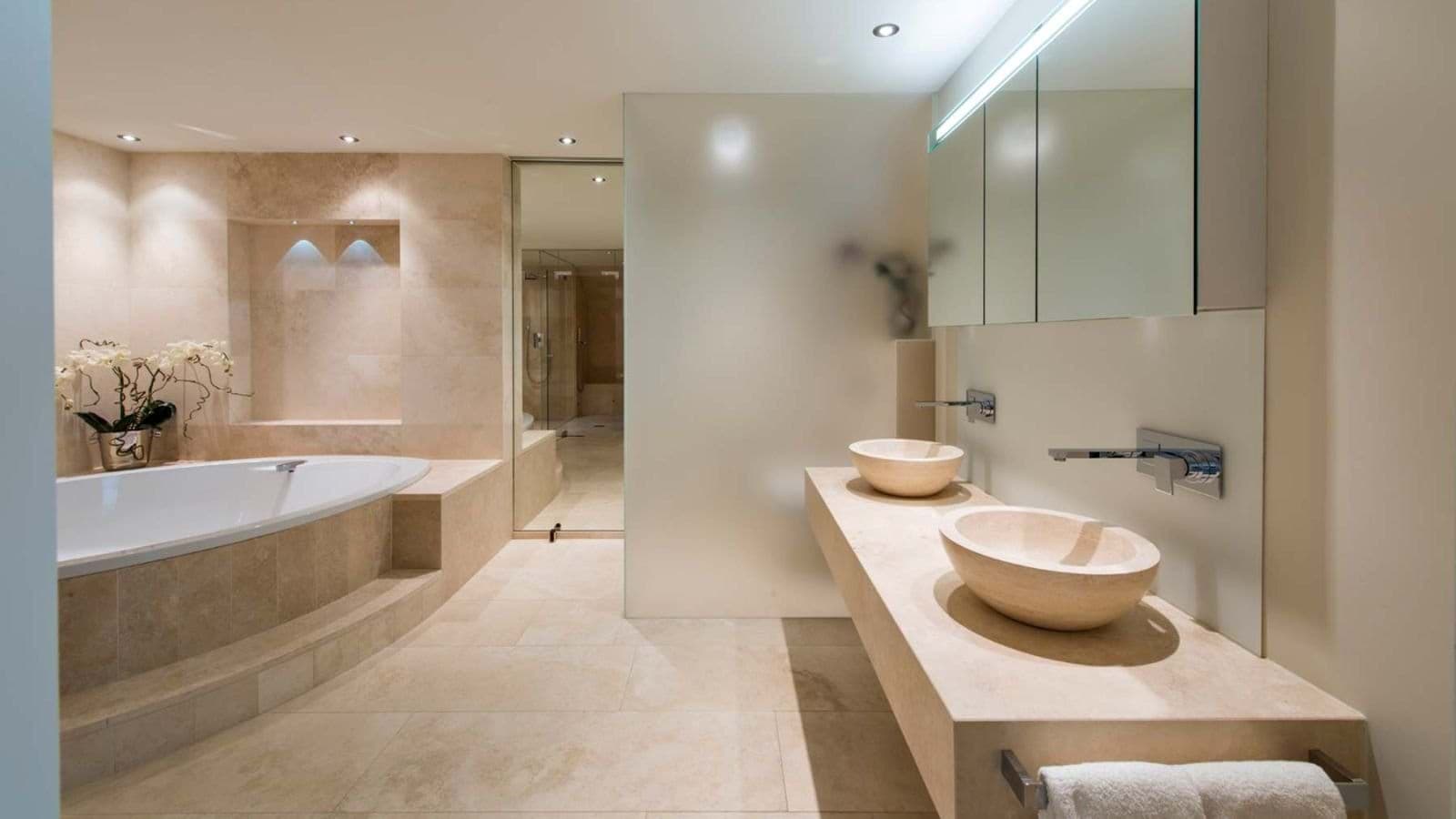 Bathroom with dual vessel sinks, soaking tub, and walk-in shower