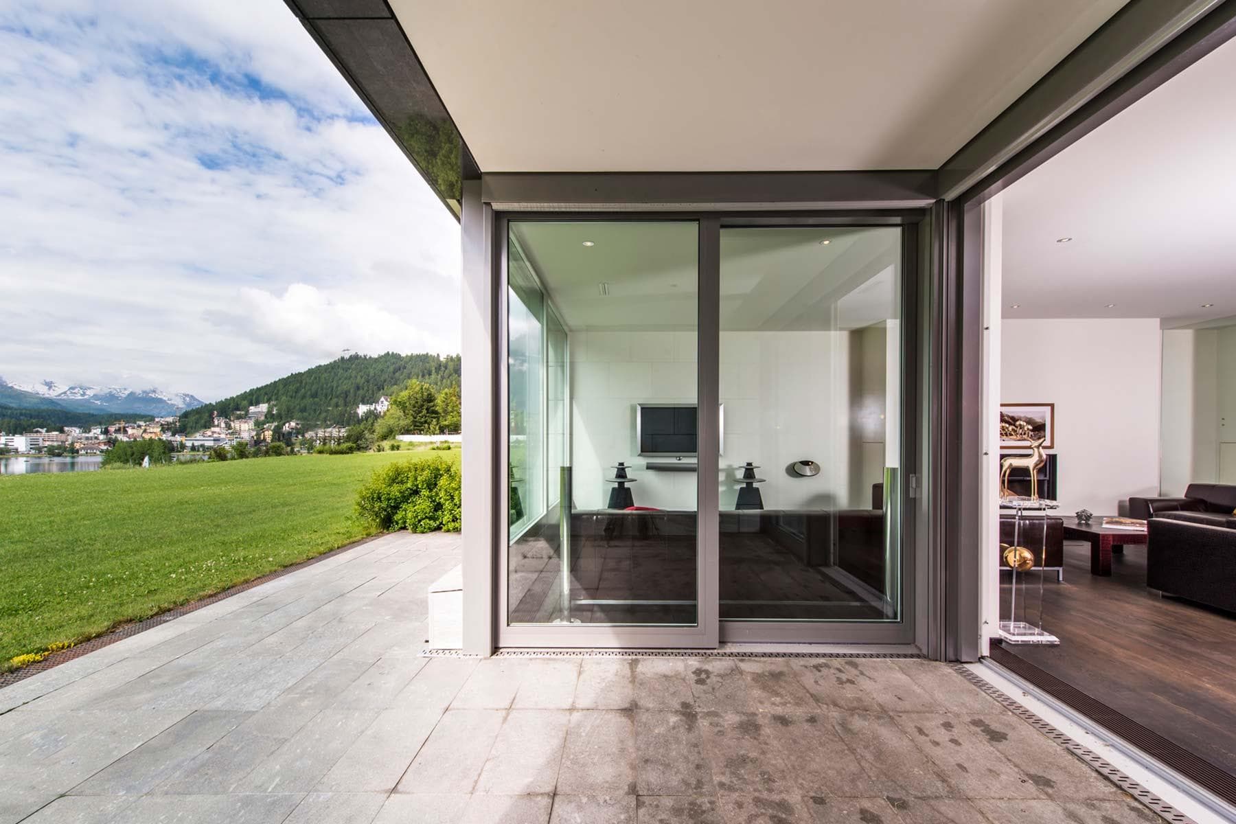 Stone patio with sliding door access and alpine lake views