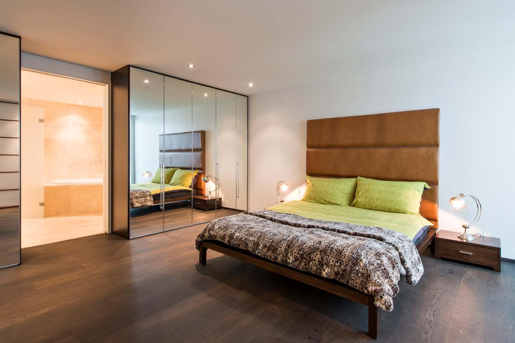 Primary bedroom with king bed and mirrored wardrobes