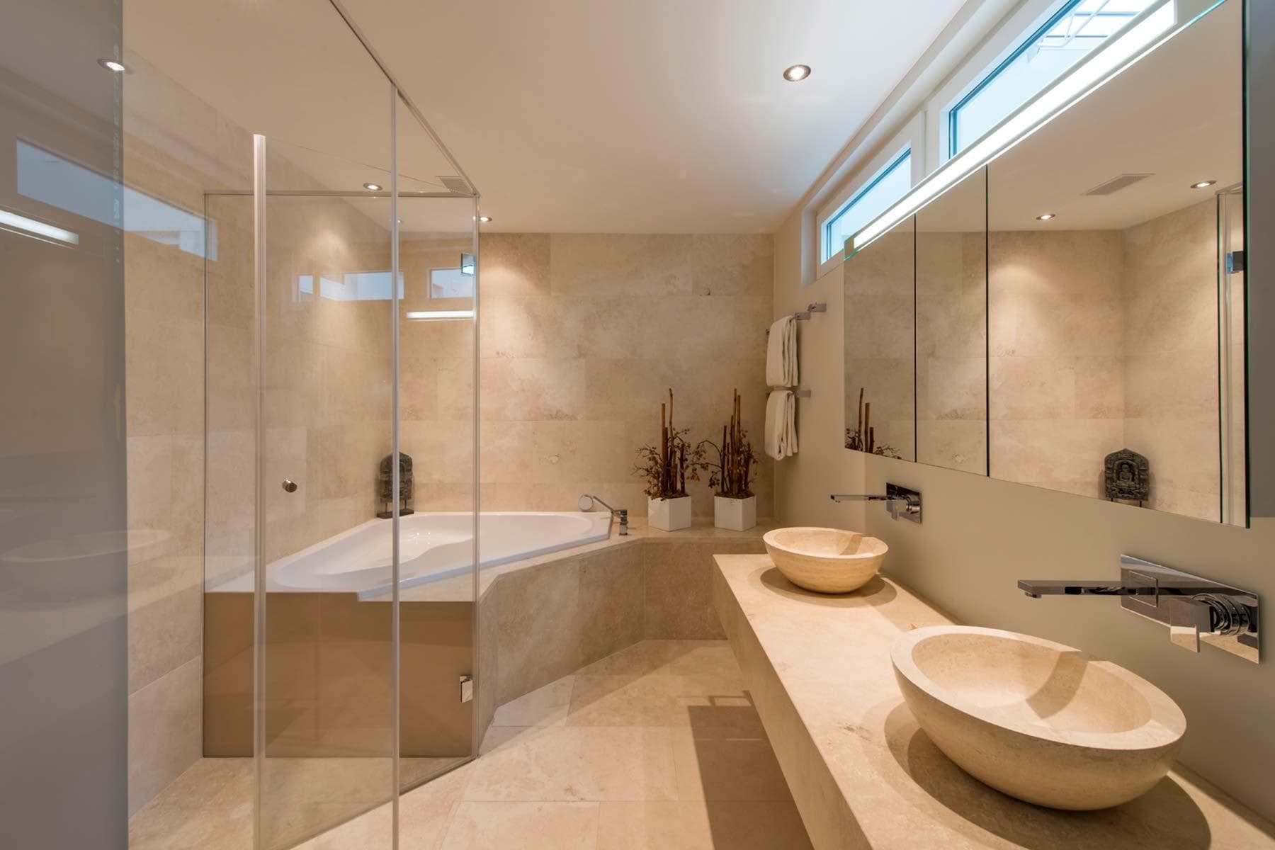 Bathroom with dual stone vessel sinks and corner soaking tub