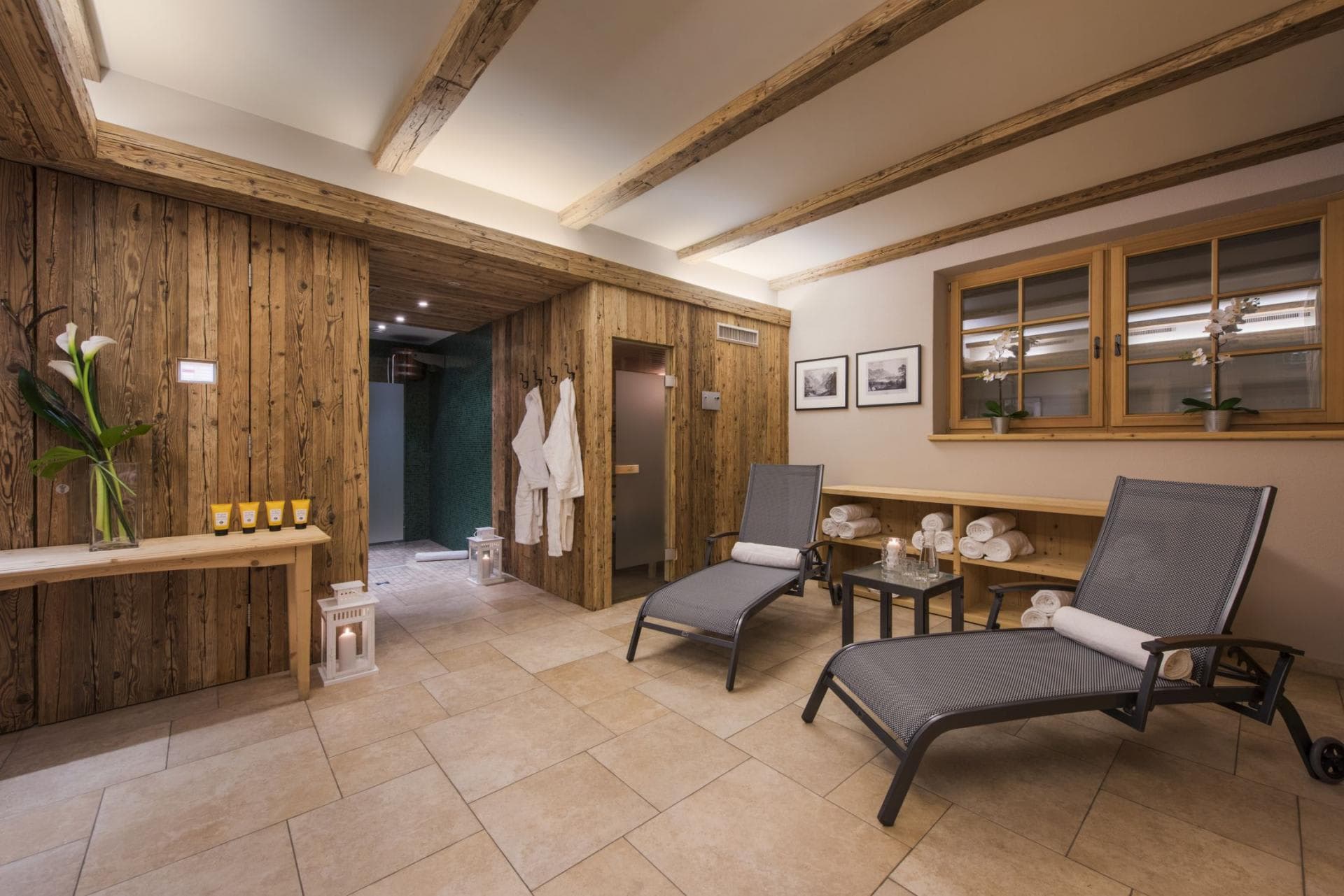 Private spa area with sauna, walk-in shower, and heated lounge seating