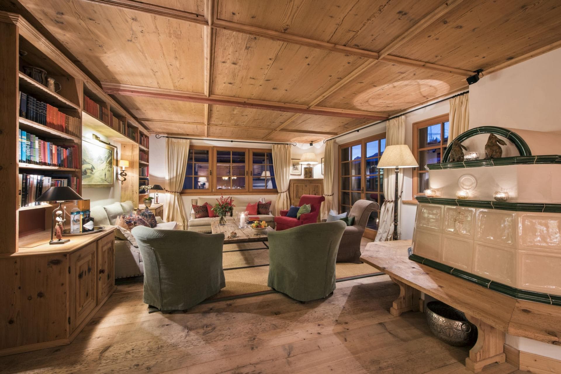 Living area with traditional tiled masonry stove and built-in library