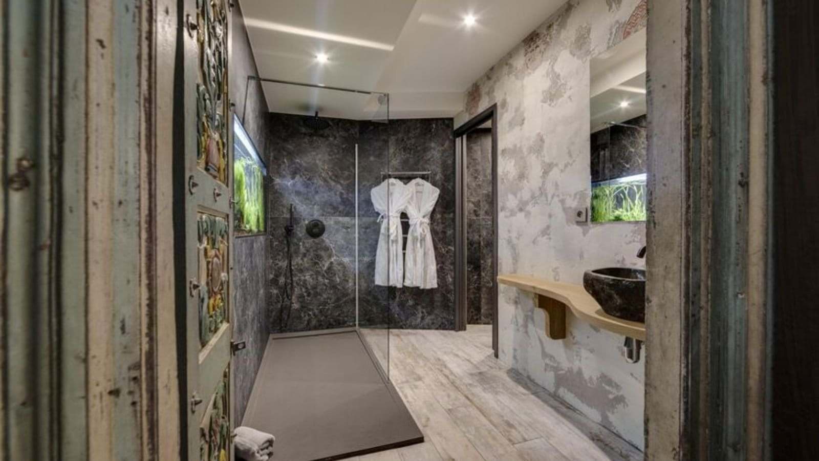 Bathroom featuring walk-in rainfall shower and built-in aquarium