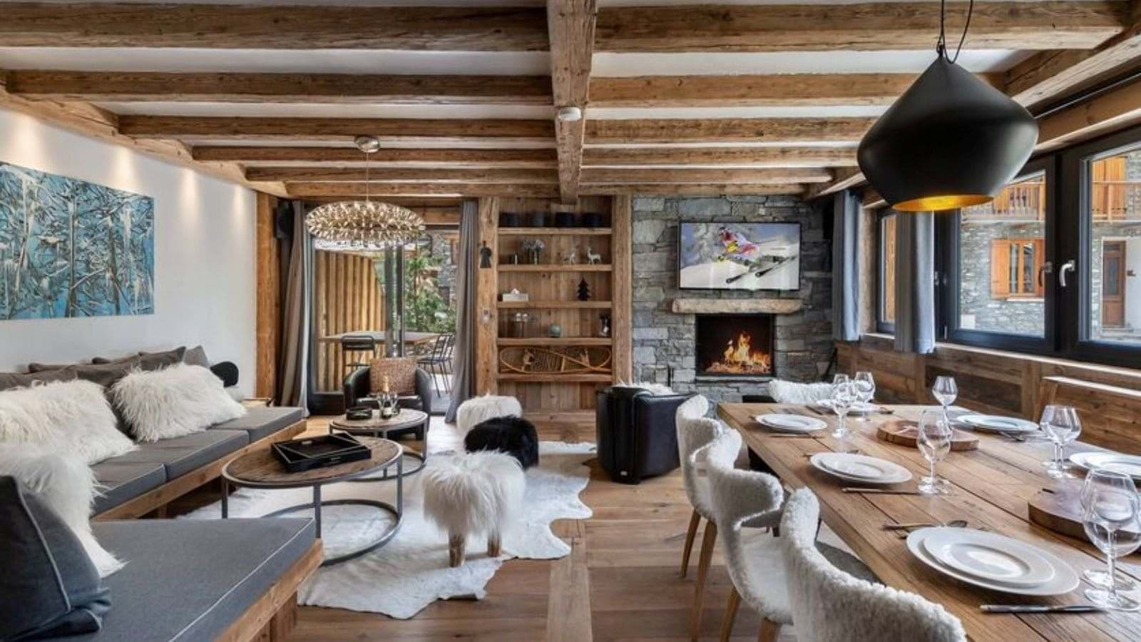 Open-plan living area with wood-burning fireplace and dining seating for 8