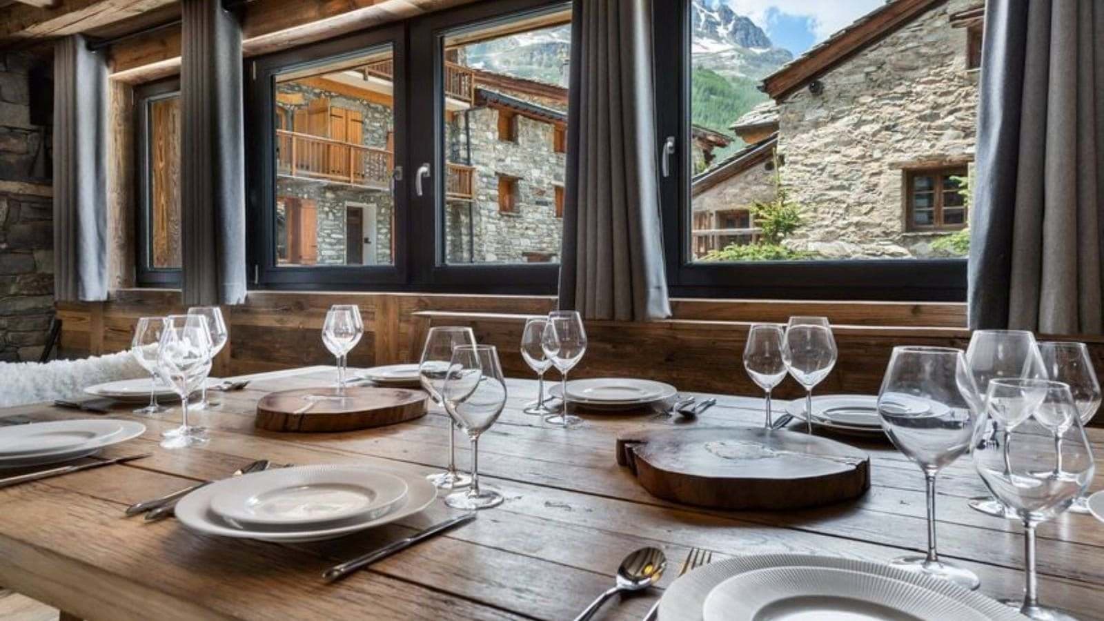Dining area with reclaimed wood table and village views