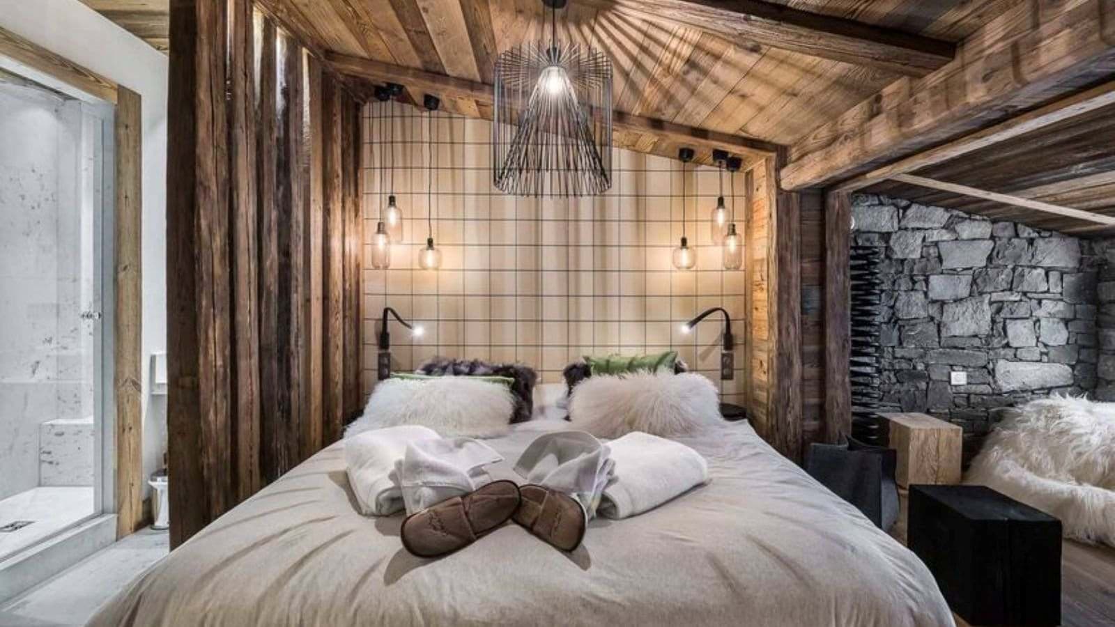 Guest bedroom with ensuite walk-in shower and stone accent wall