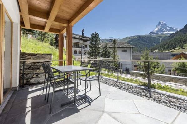 Covered deck with dining table; Matterhorn views over alpine village
