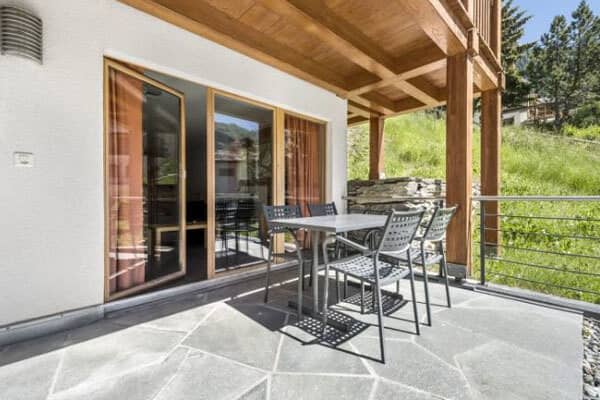 Covered deck with dining table for 4; cable railing and mountain views