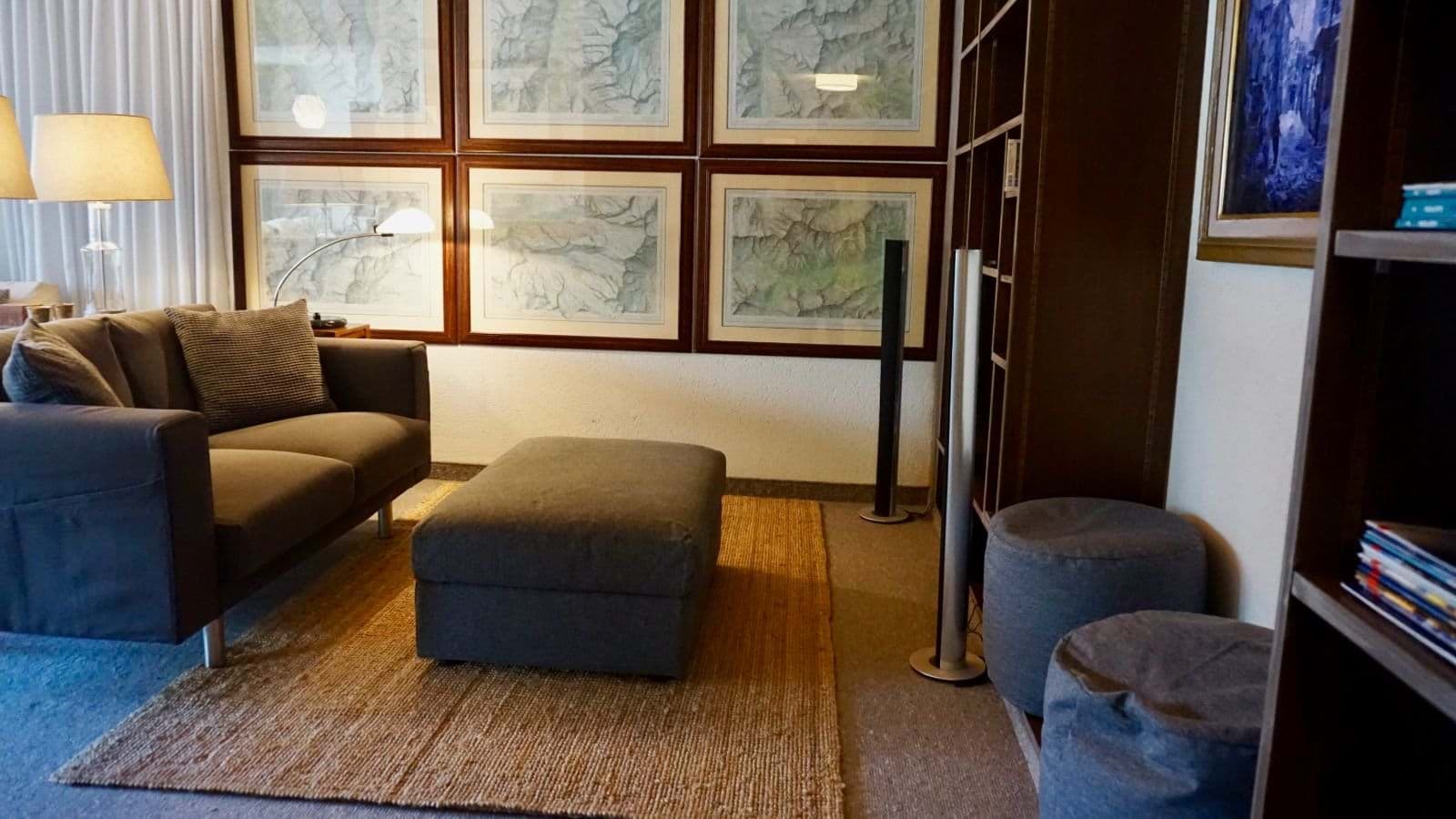 Media room with sectional sofa, ottoman, and tower speakers