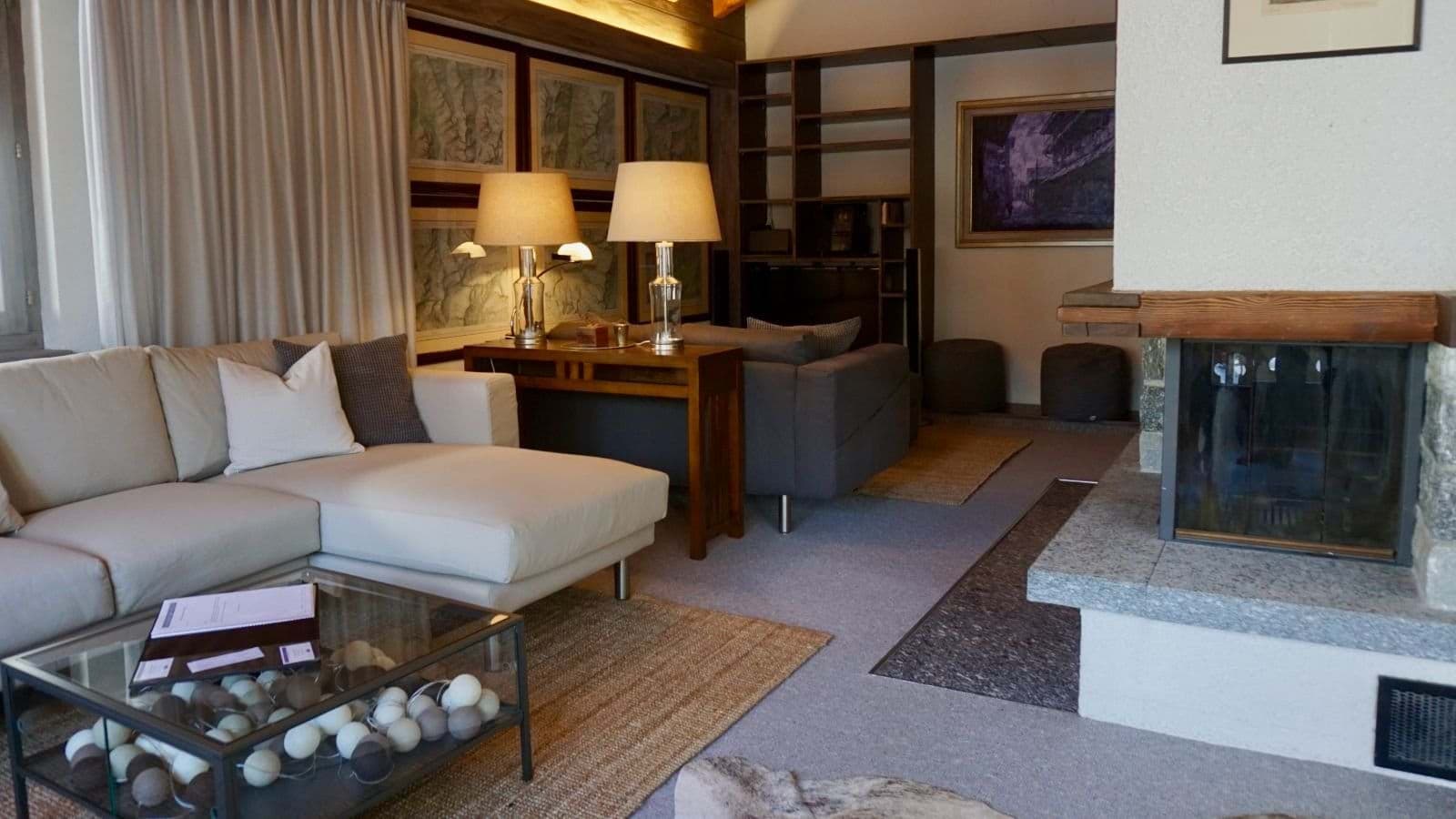 Living area with wood-burning fireplace and sectional sofa seating