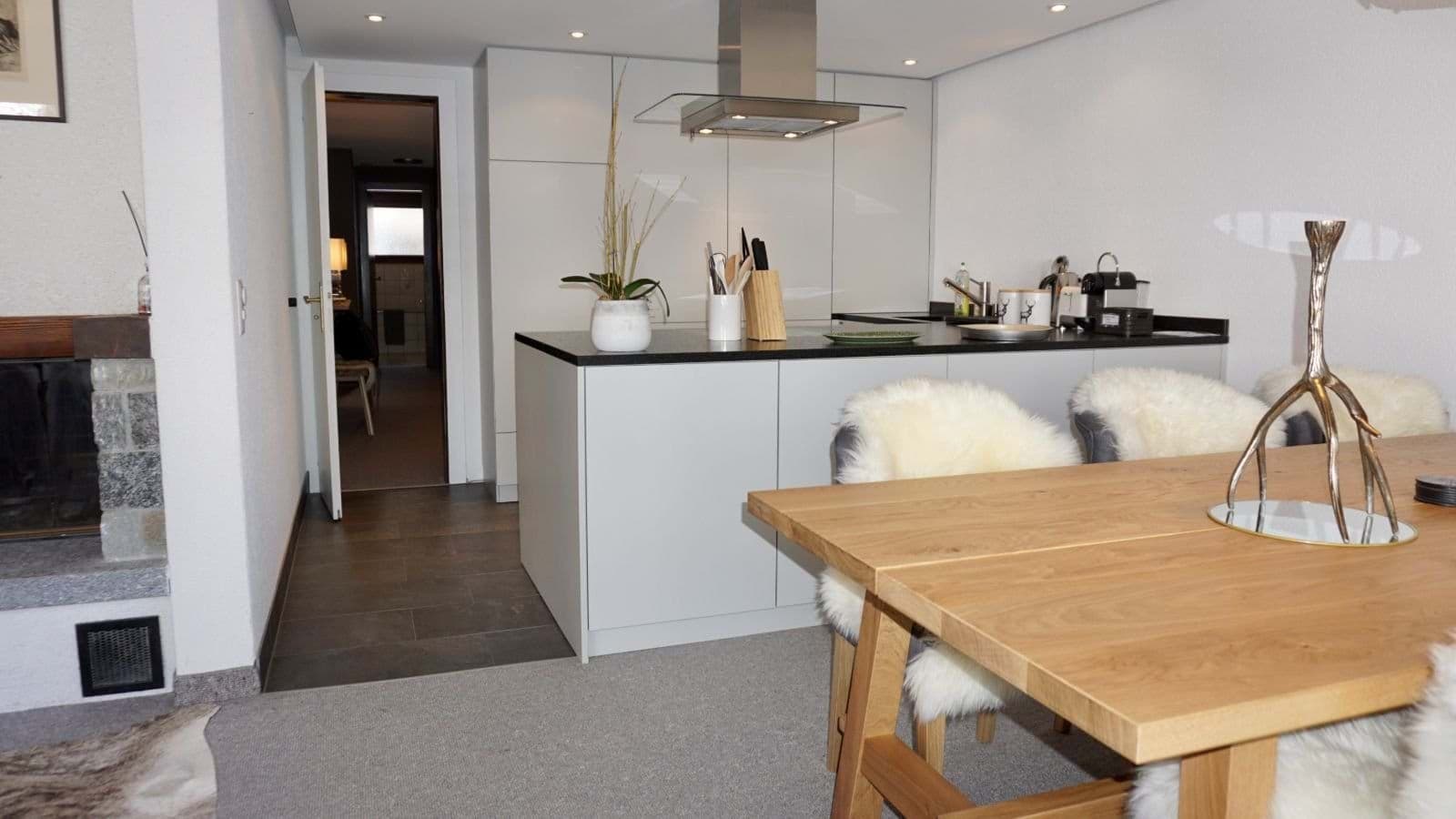Open-plan kitchen with induction cooktop and Nespresso coffee machine