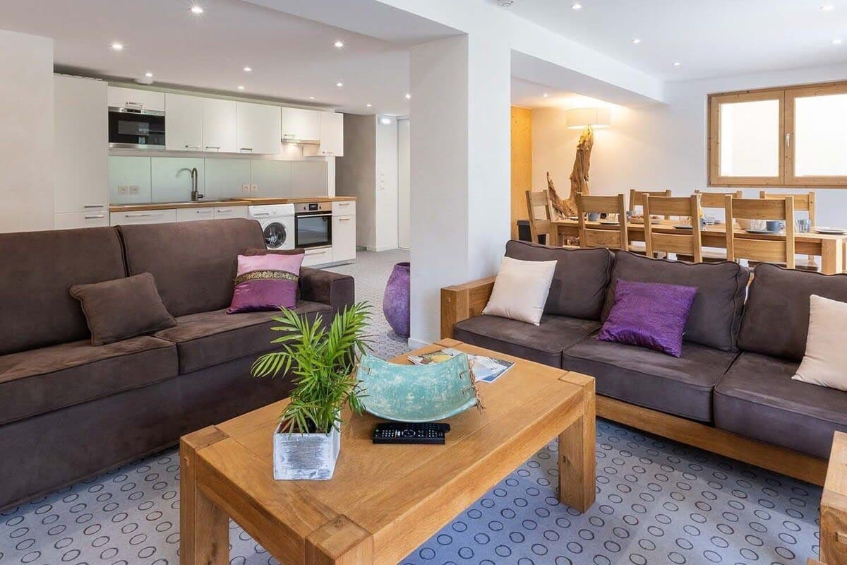 Living area with integrated kitchen, washer, and dining for 8