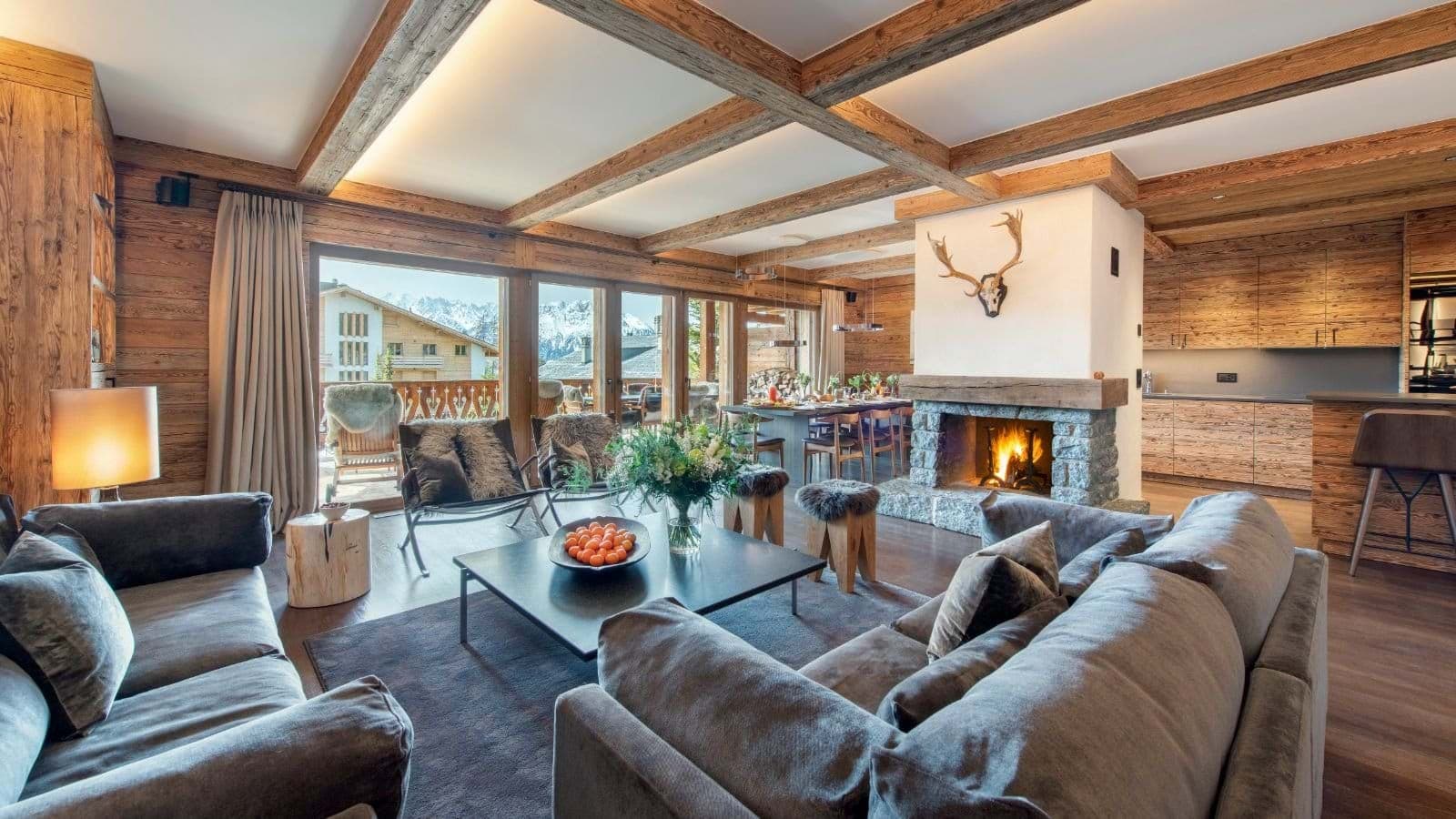 Open-plan living area with stone fireplace and terrace access
