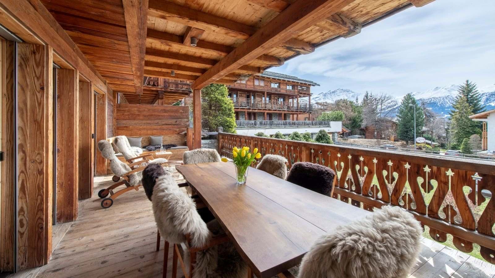 Covered timber balcony with dining for 6 and mountain peak views