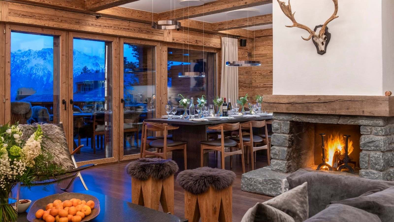Dining area with seating for 10, stone fireplace, and mountain views
