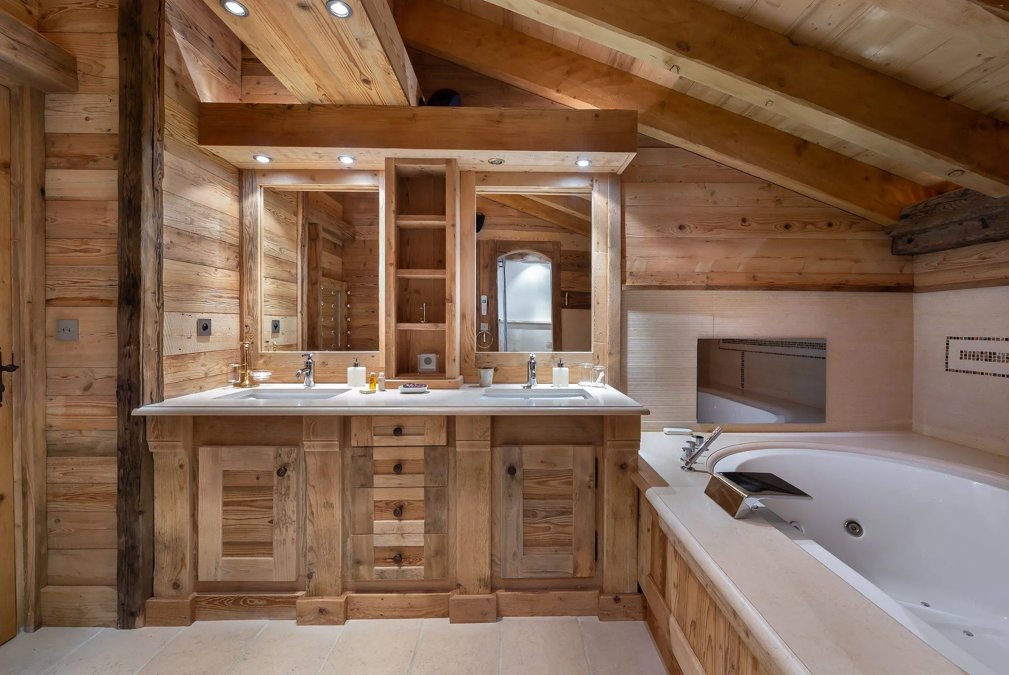 Bathroom with a whirlpool bath and twin basins