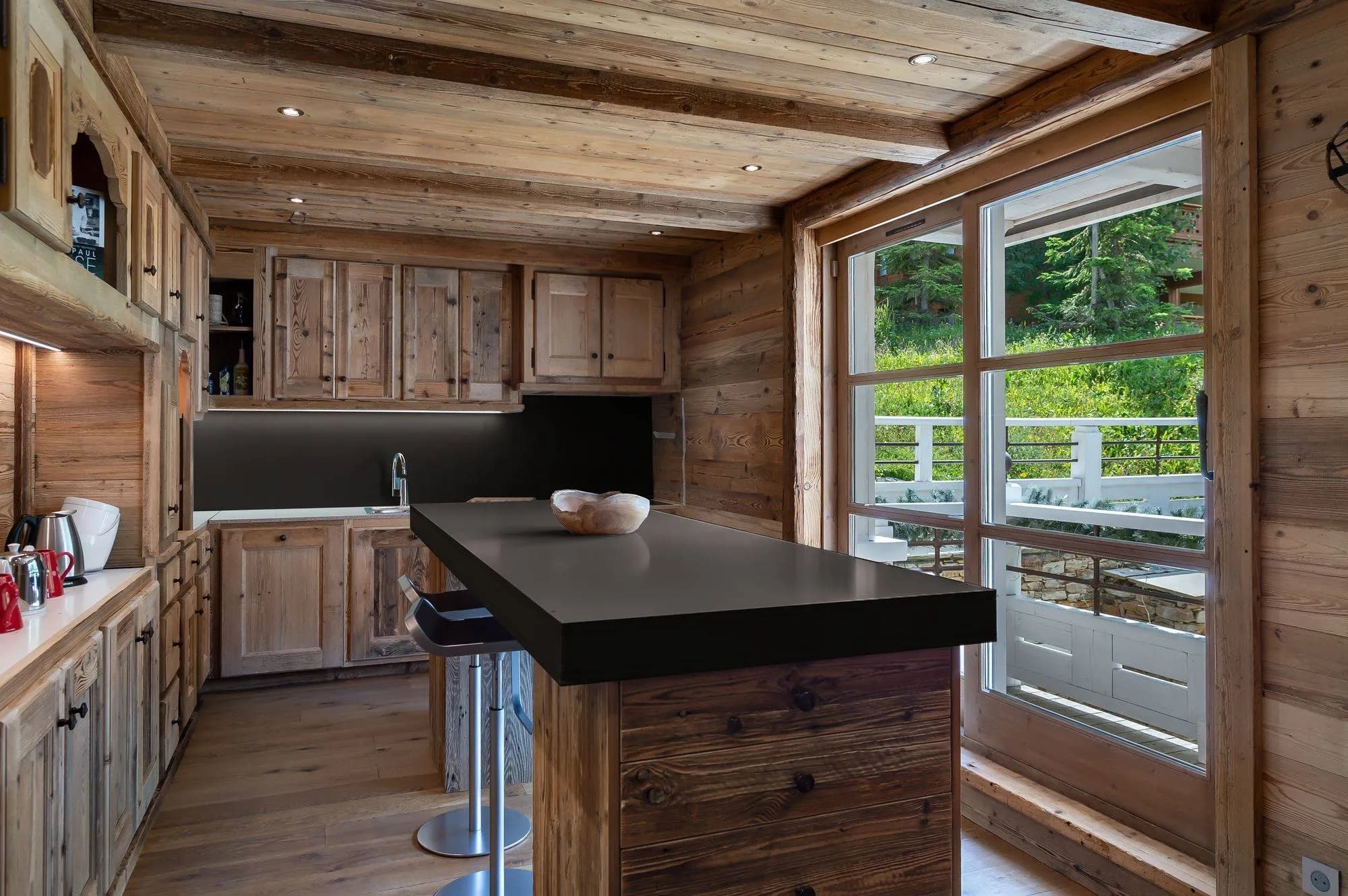 Fitted kitchen with an island and counter stools
