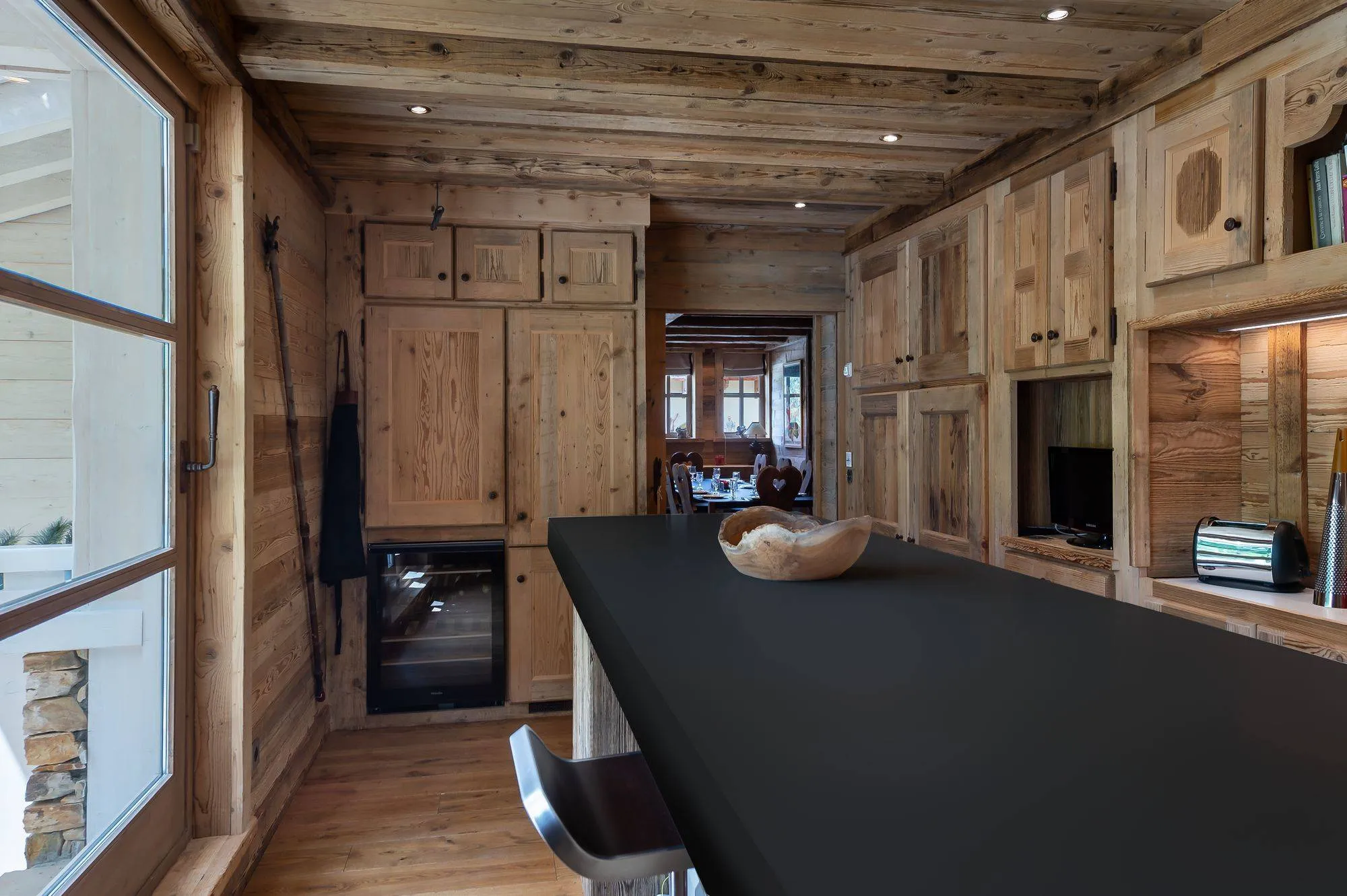 Kitchen island beside fitted timber cabinetry