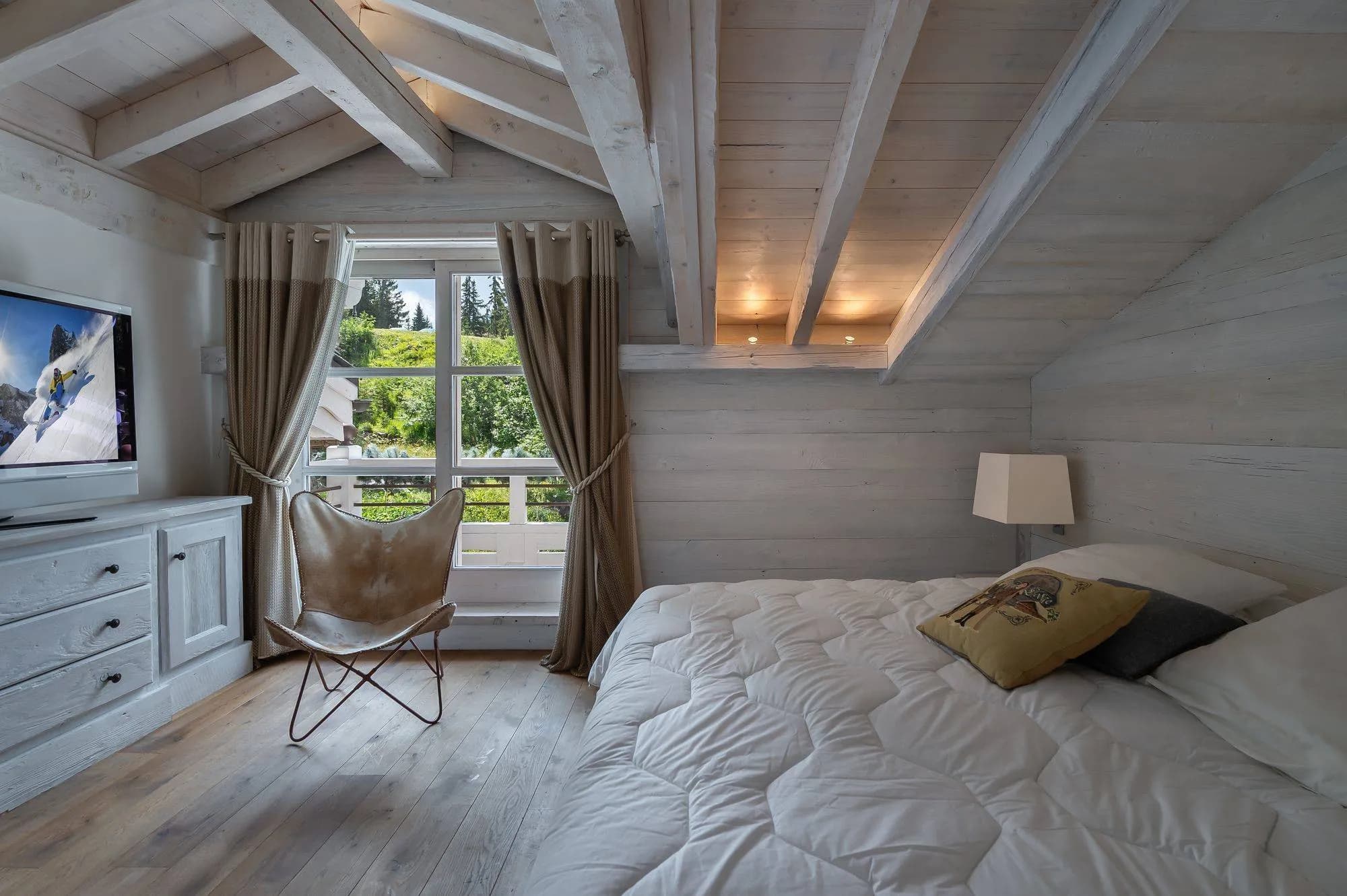 Bedroom with pale timber walls and a glazed door