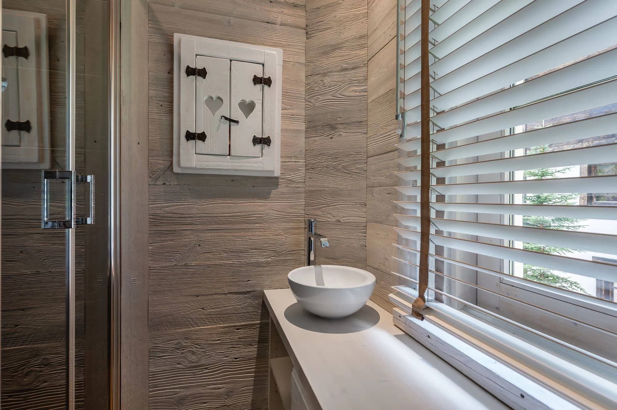 Bathroom with a vessel basin beside a window