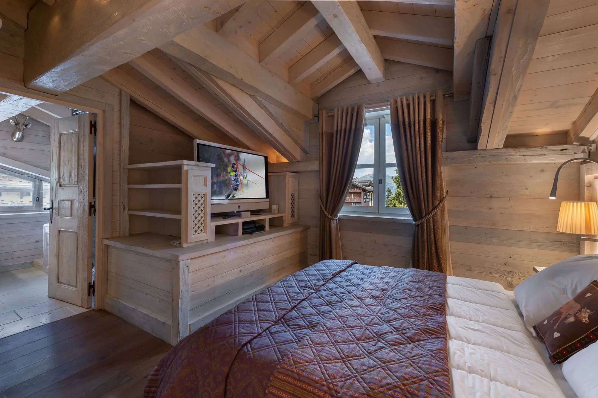 Double bedroom beneath a sloping timber ceiling