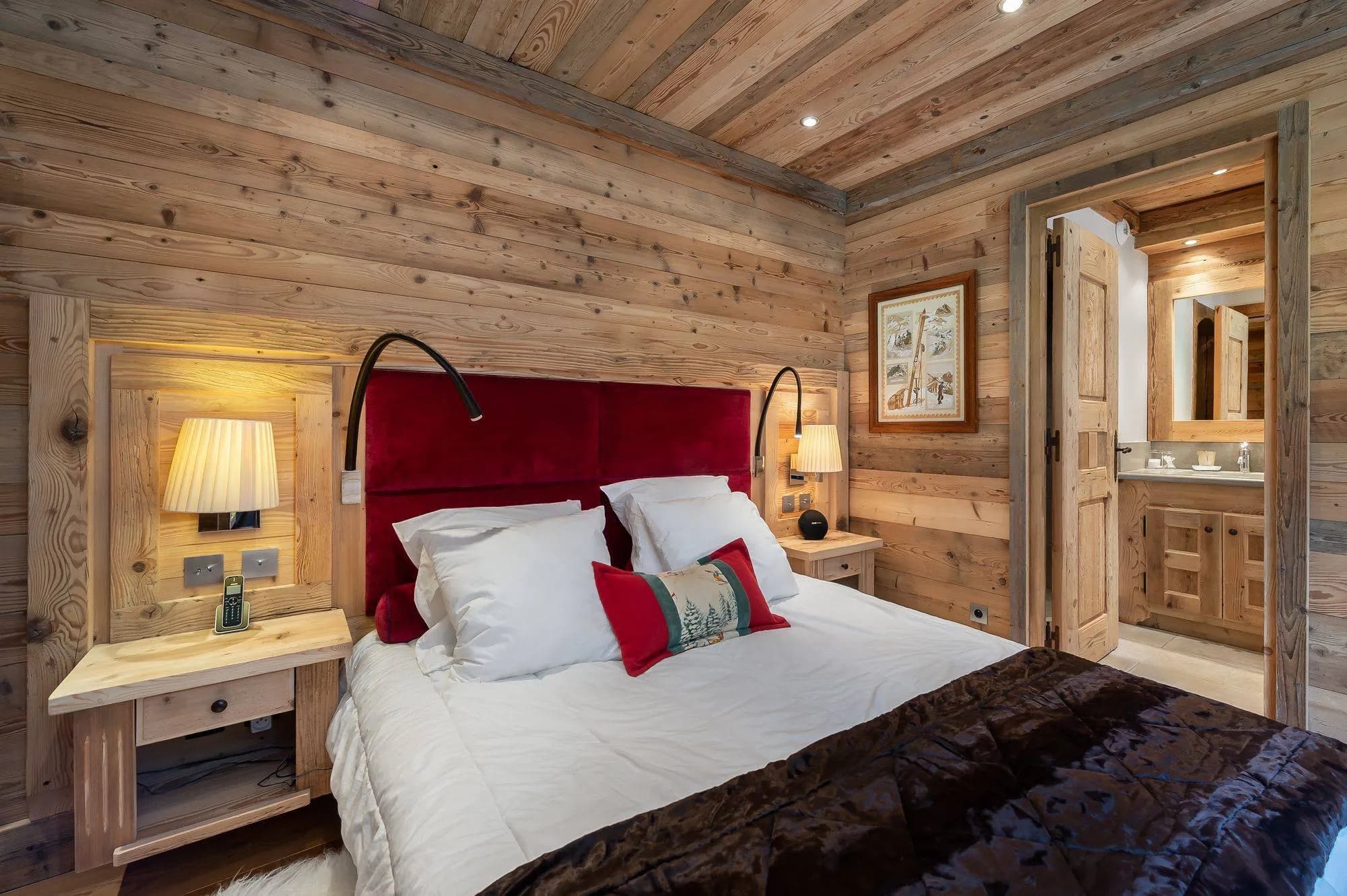Double bedroom with a red headboard and timber walls