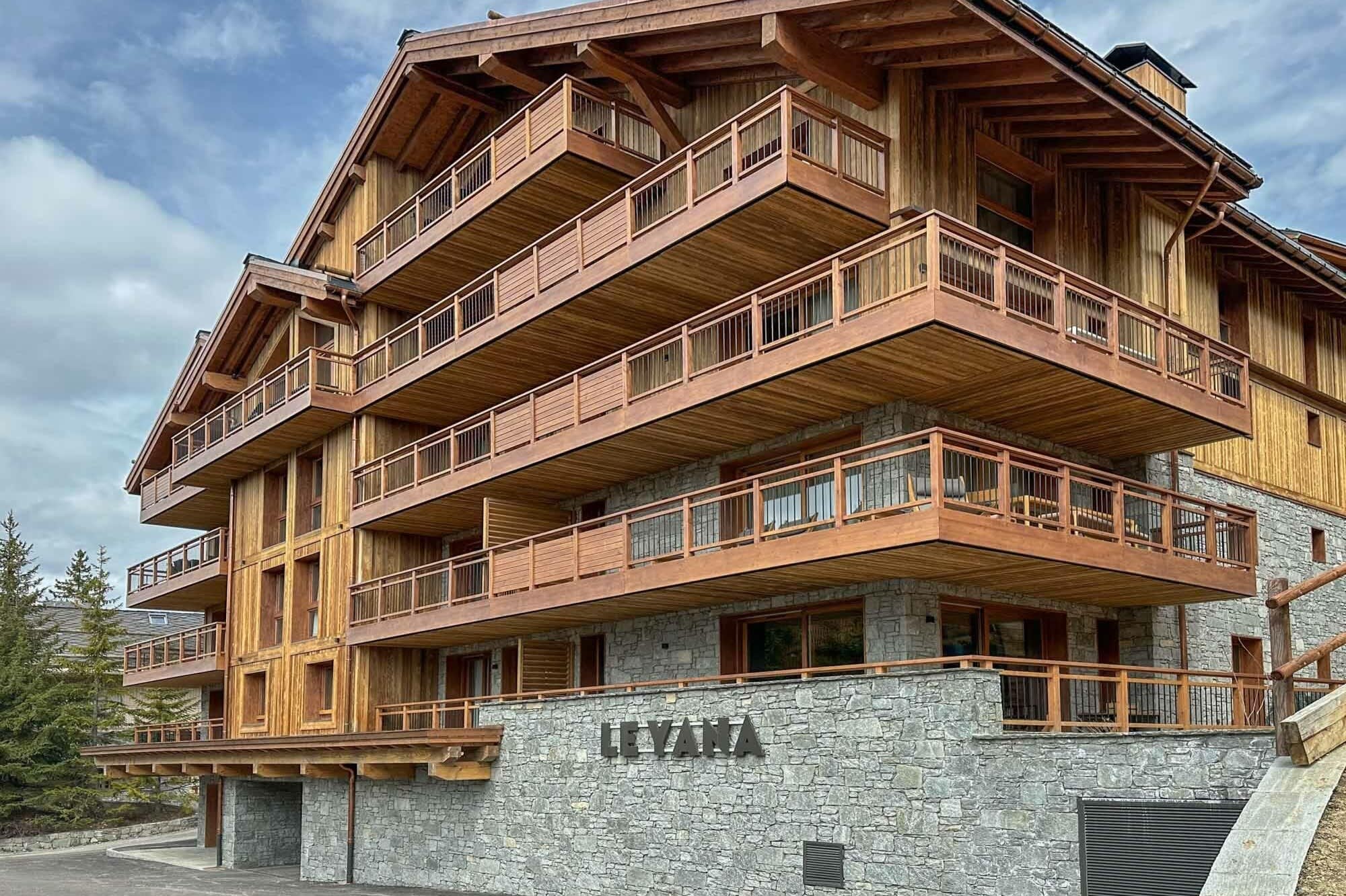 Chalet exterior with stone facade and private balconies for each floor