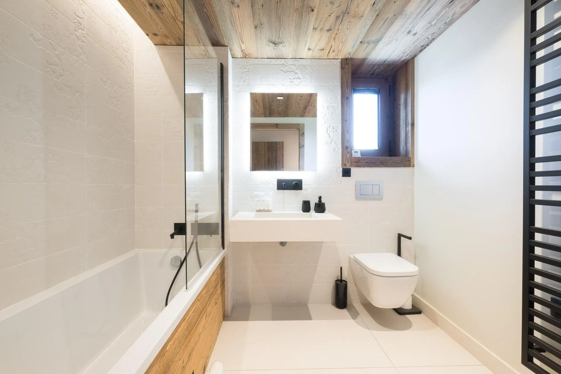 Bathroom with bath and heated towel rail