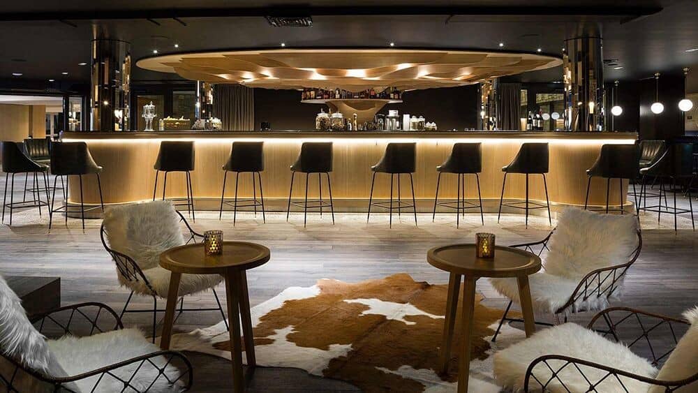 Lobby bar with seating for 10; additional lounge tables with faux-fur chairs