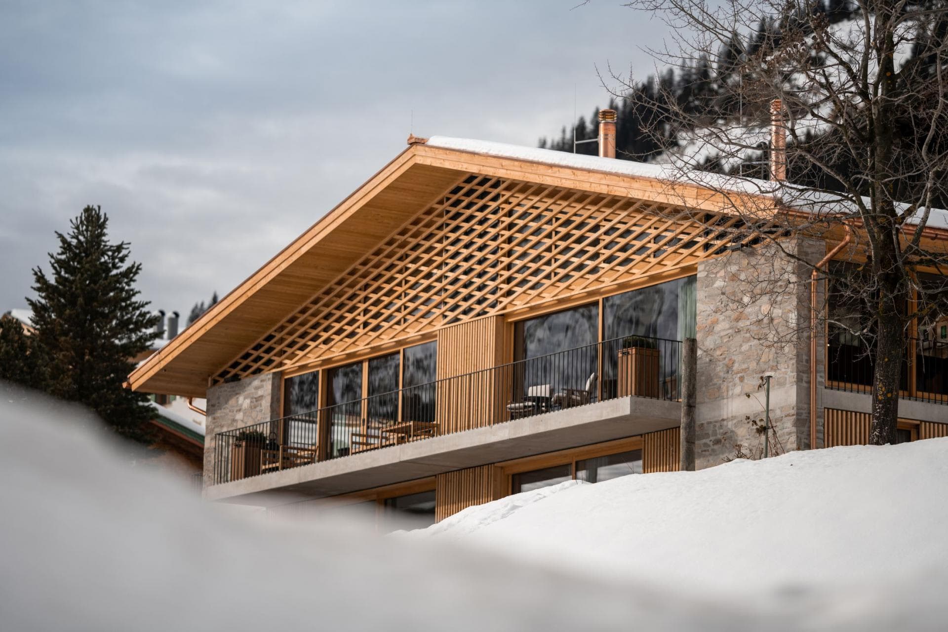 Chalet exterior with stone masonry and private balconies overlooking the slopes