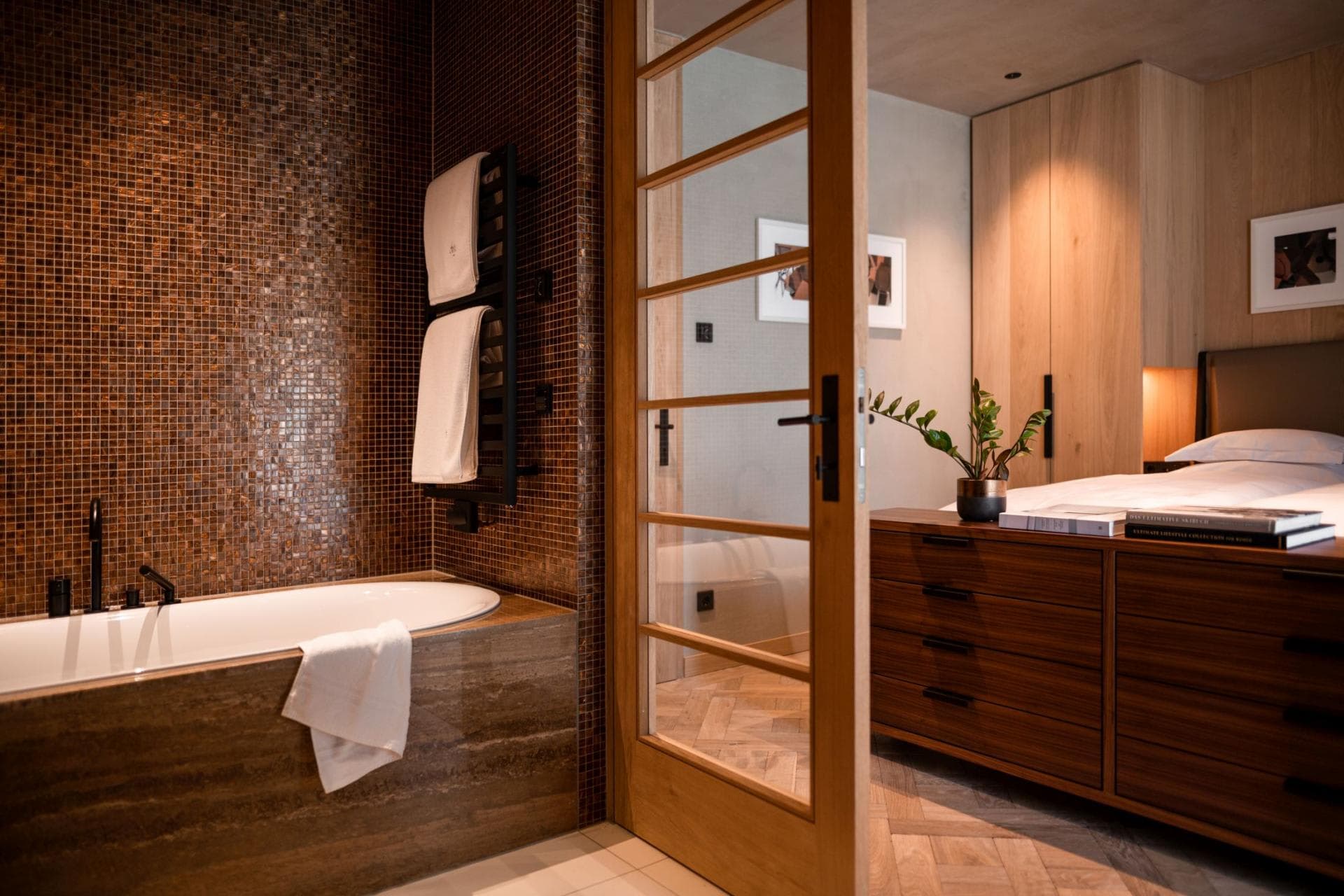 En suite bathroom with soaking tub and heated towel rail