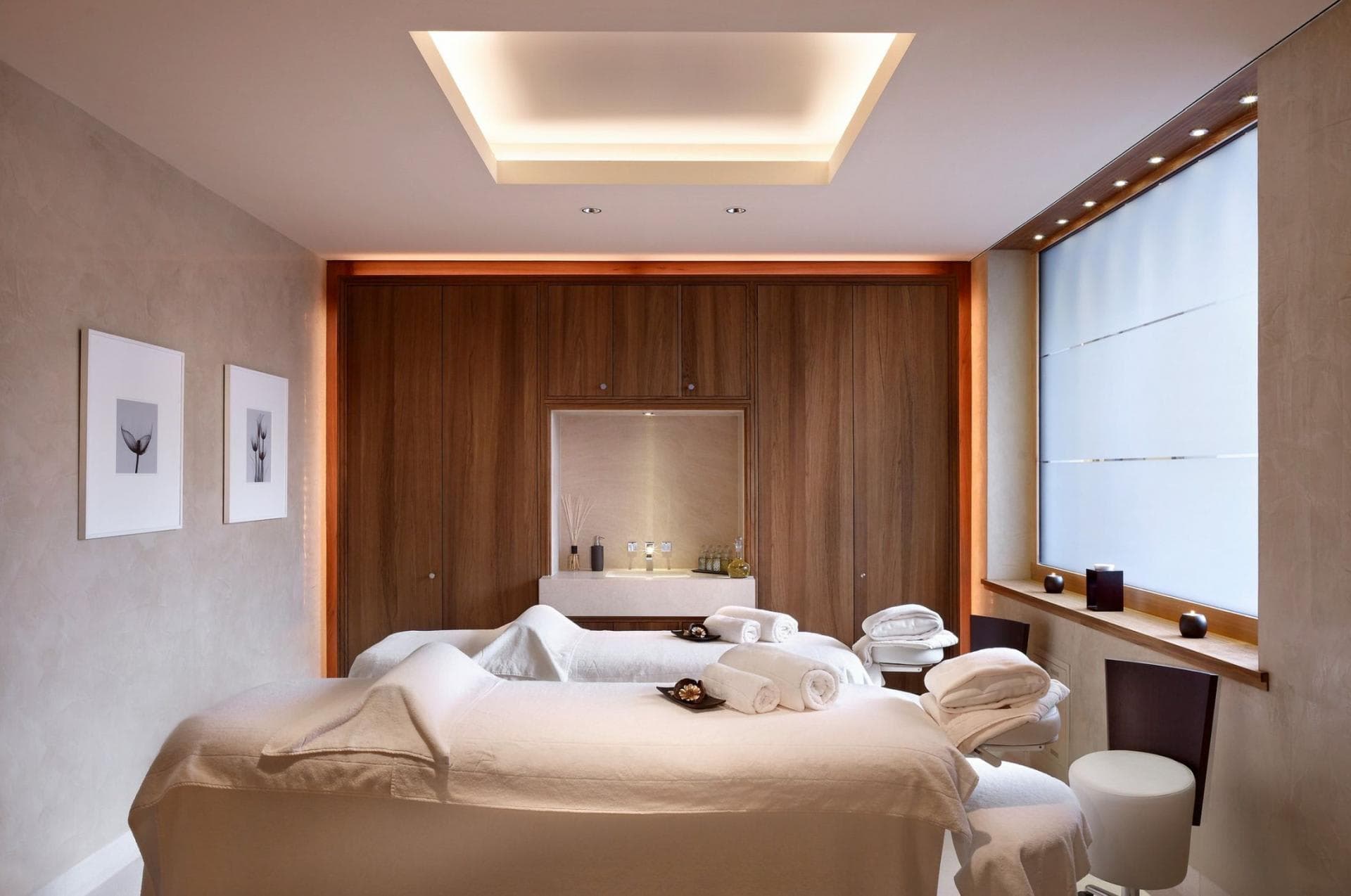 Private spa room with dual massage tables and integrated vanity sink