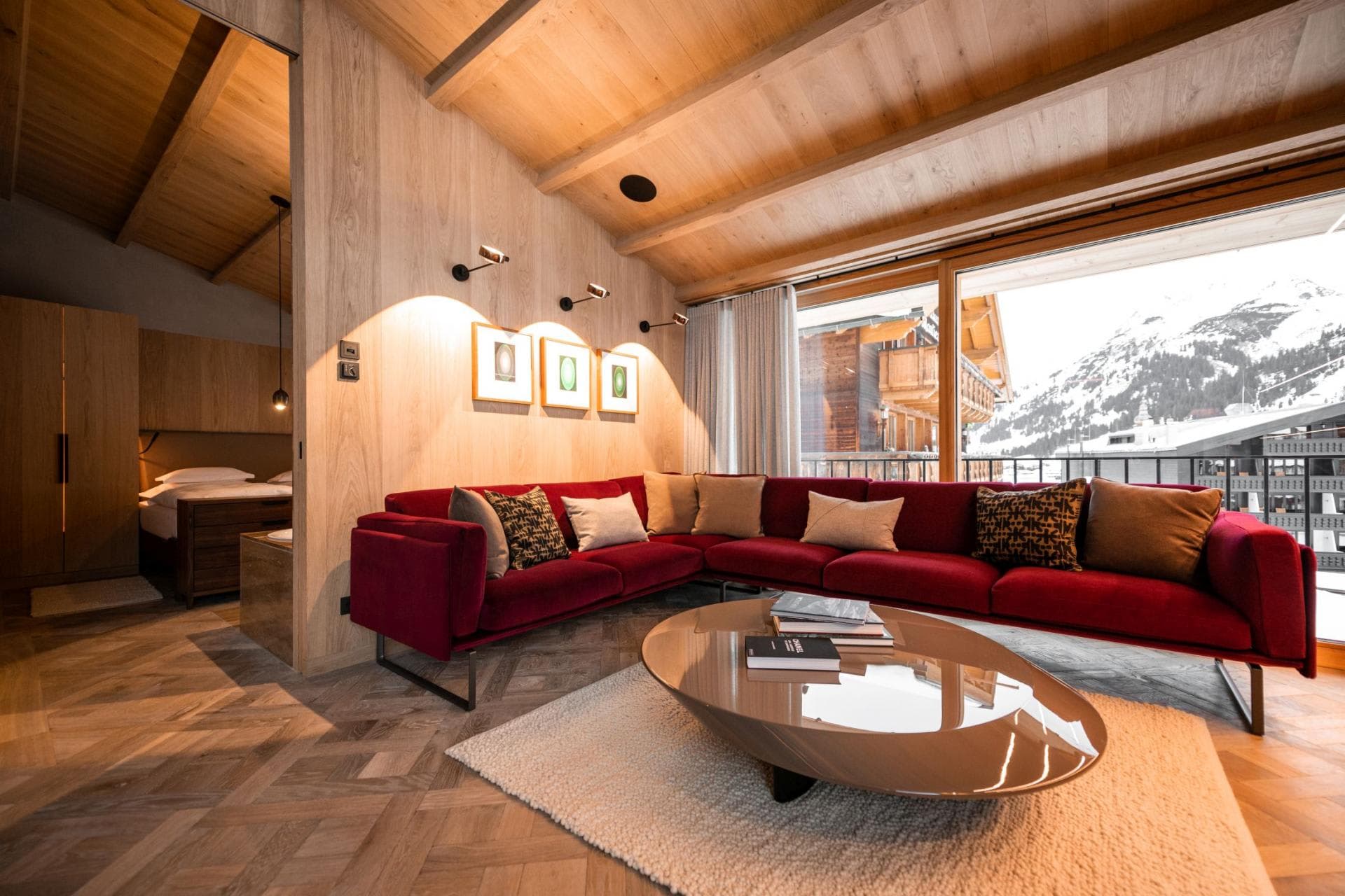Living area with mountain views and adjacent bedroom alcove