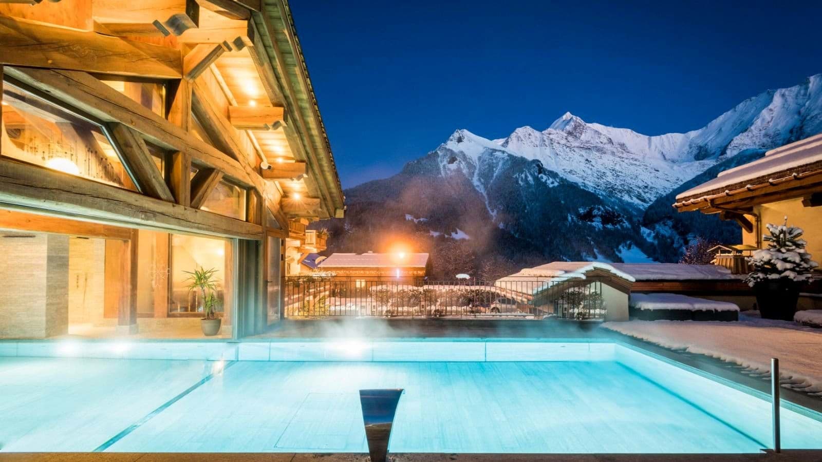 Heated outdoor pool with mountain views and indoor-outdoor swim access