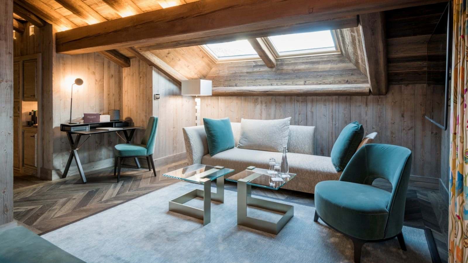 Seating area with skylights, dedicated workspace, and herringbone wood floors