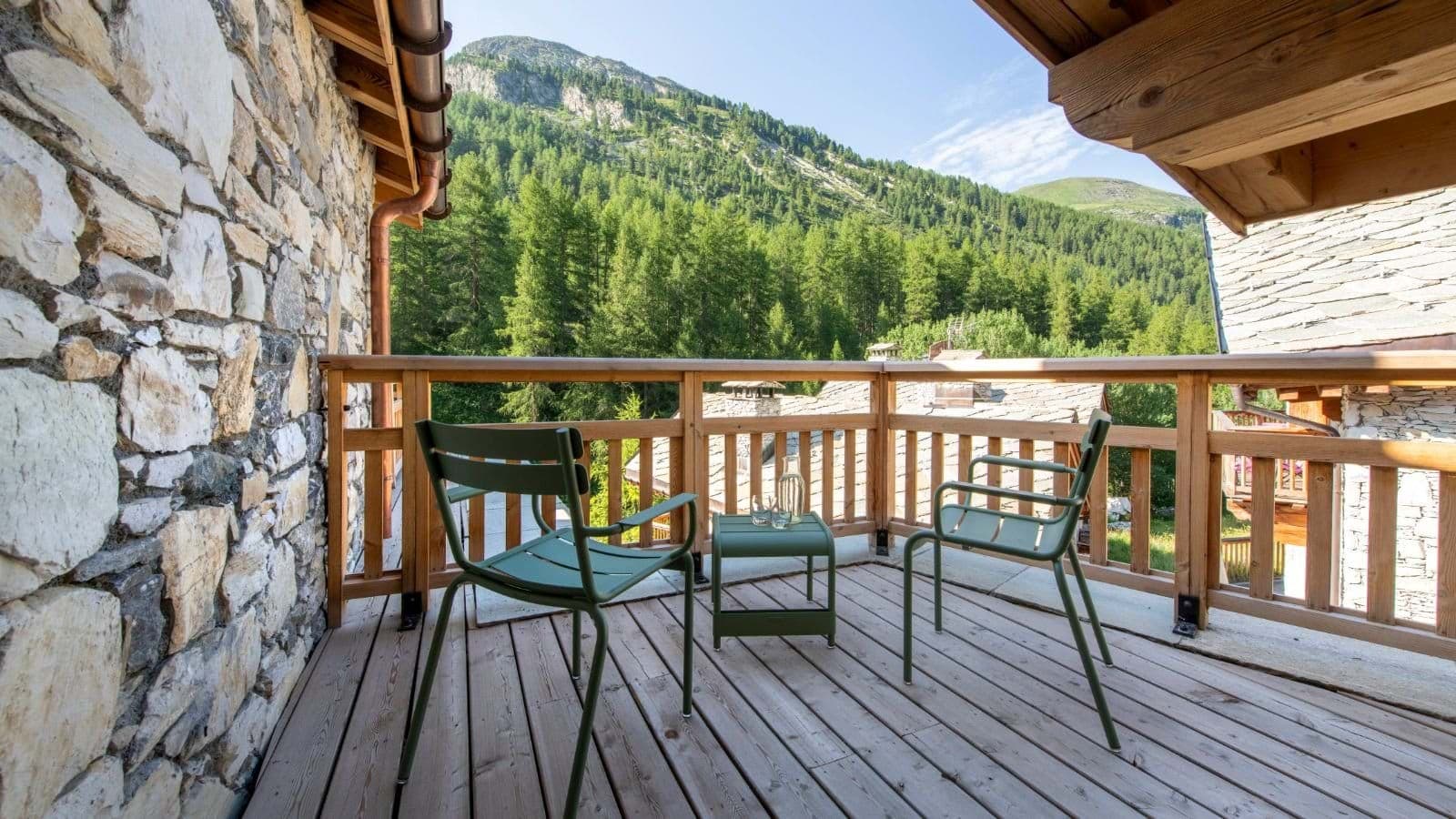 Private balcony with seating for two and mountain forest views
