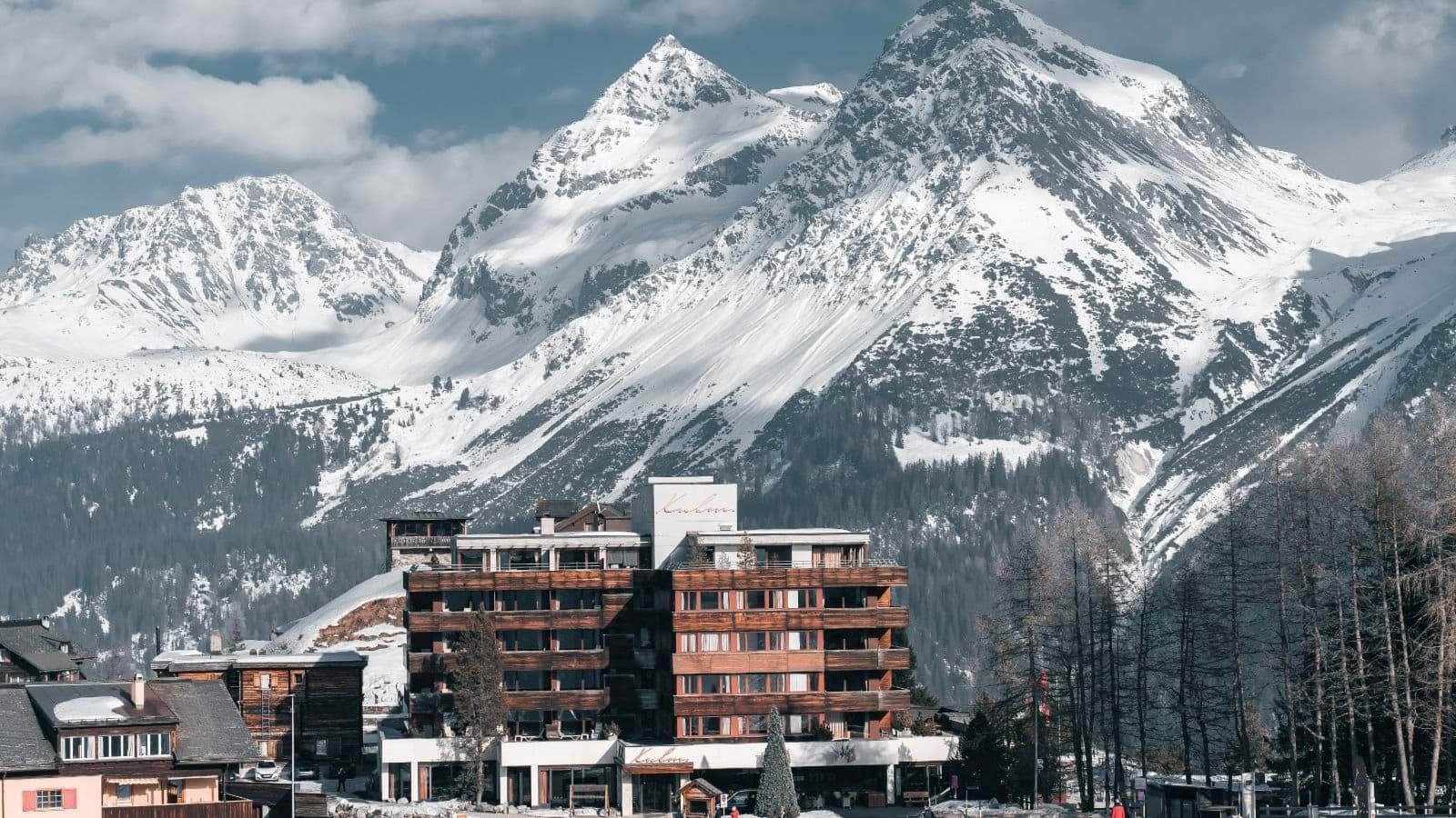 Ski-in/ski-out lodge at the base of snow-capped Alpine peaks