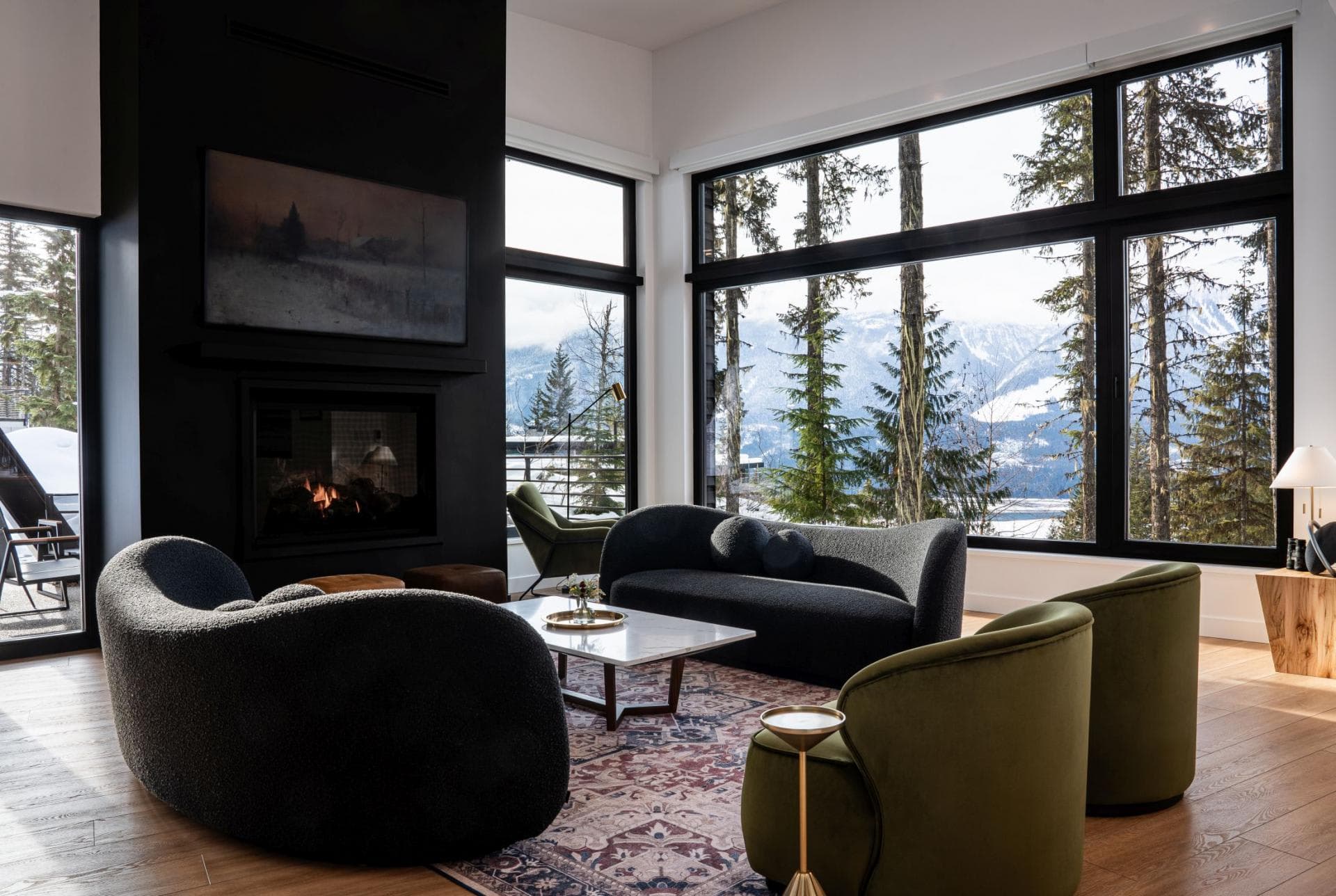 Living area with gas fireplace and floor-to-ceiling mountain views