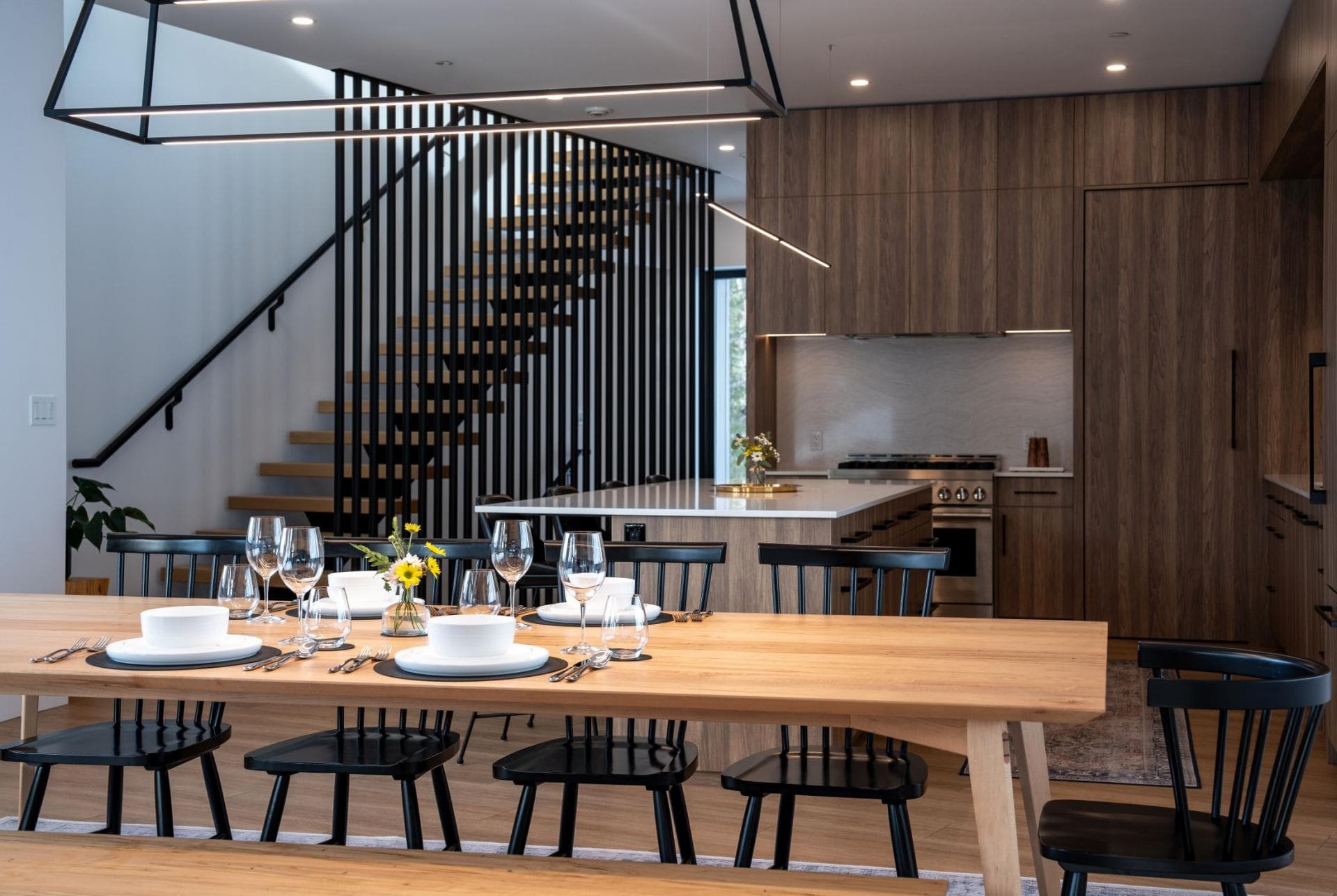 Open-plan dining area with seating for 8 and adjacent chef's kitchen