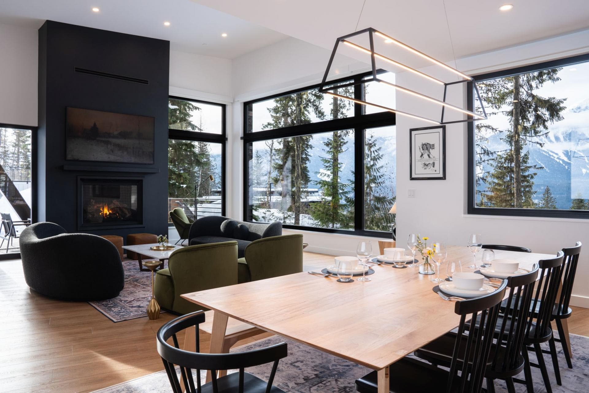 Open-plan dining and living area with gas fireplace and mountain views