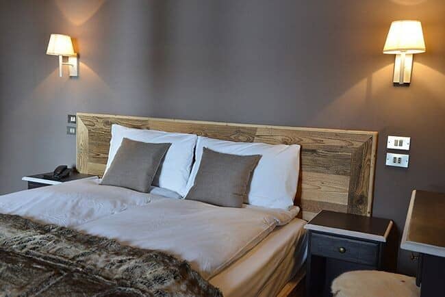 Bedroom with king bed and bedside integrated lighting and power outlets