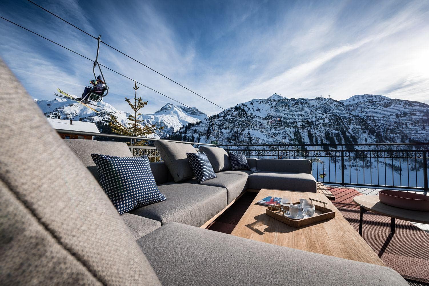 Private terrace lounge with sectional seating and ski lift views