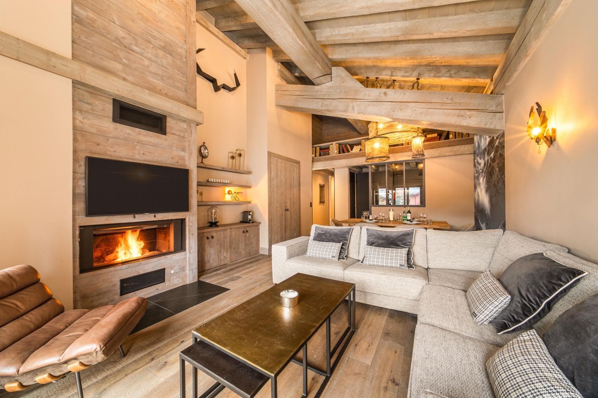 Living area with wood-burning fireplace and exposed timber beams